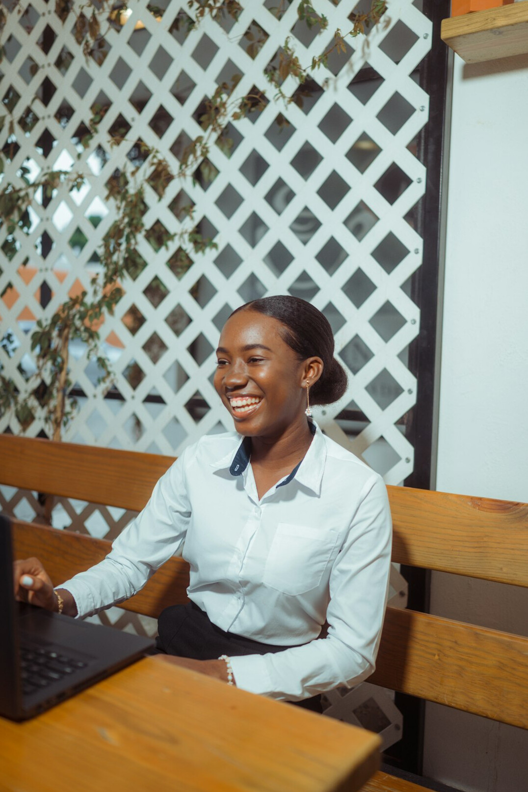 person smiling at laptop screen
