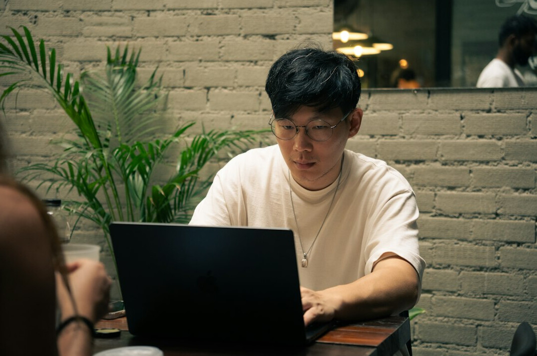 japanese student coding on laptop